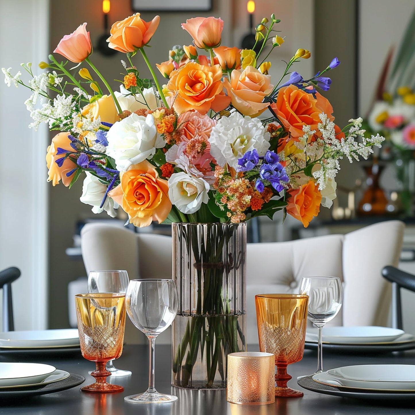 Colorful flower arrangement in a vase on a dining table with glasses and plates.