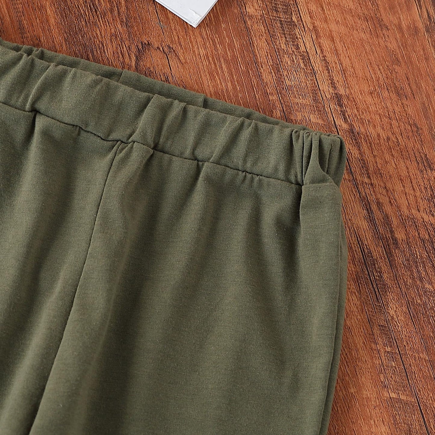 Green pants on a wooden floor