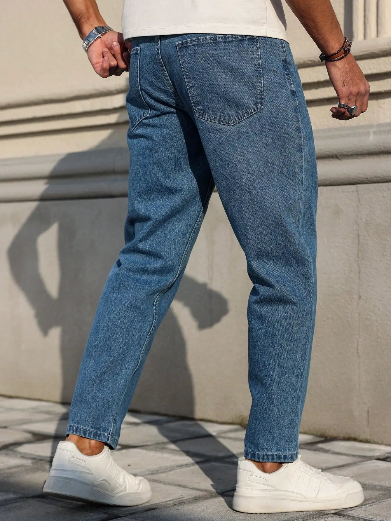 Men's jeans are made of classic blue denim fabric with a loose fit