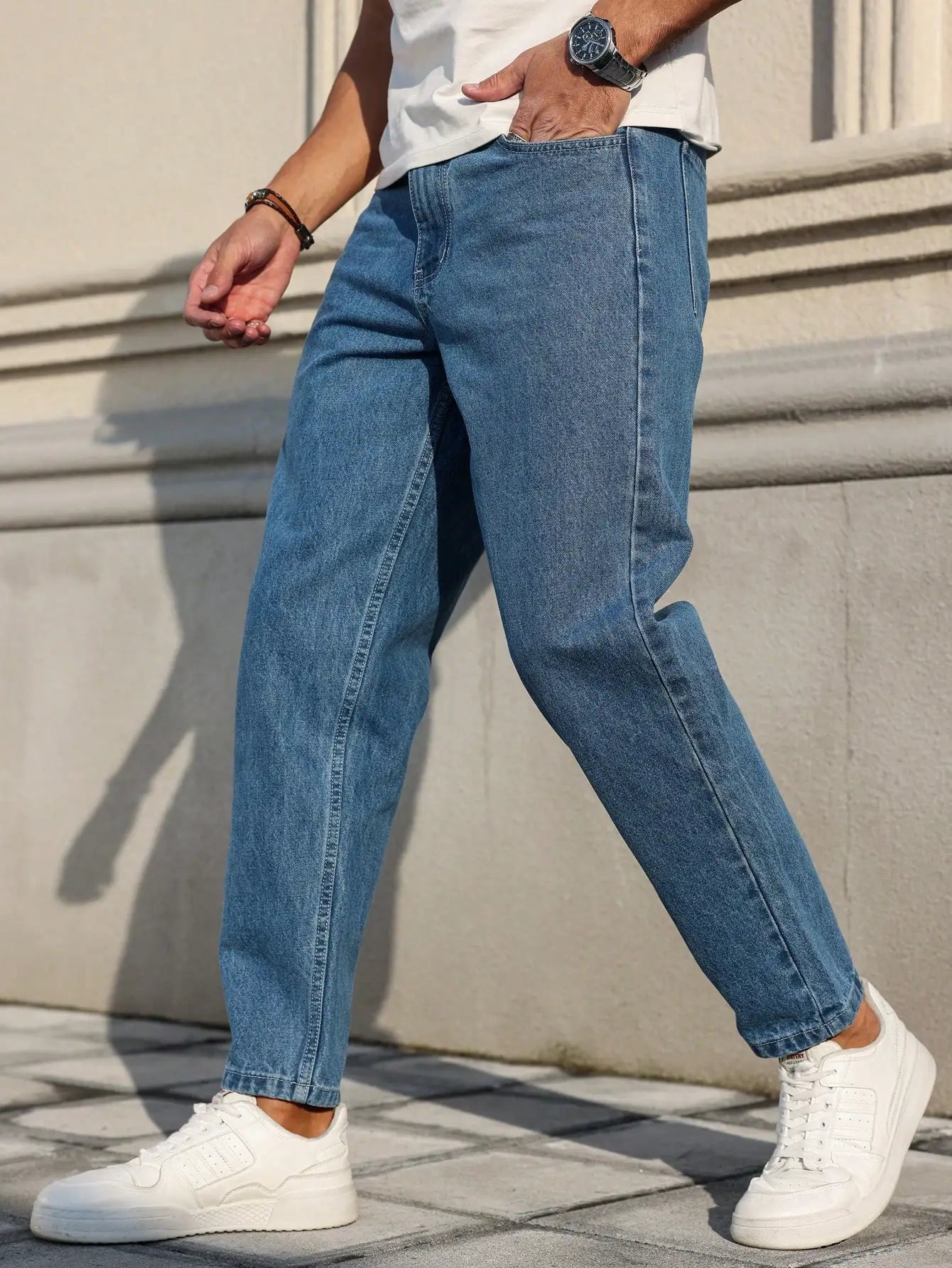 Men's jeans are made of classic blue denim fabric with a loose fit