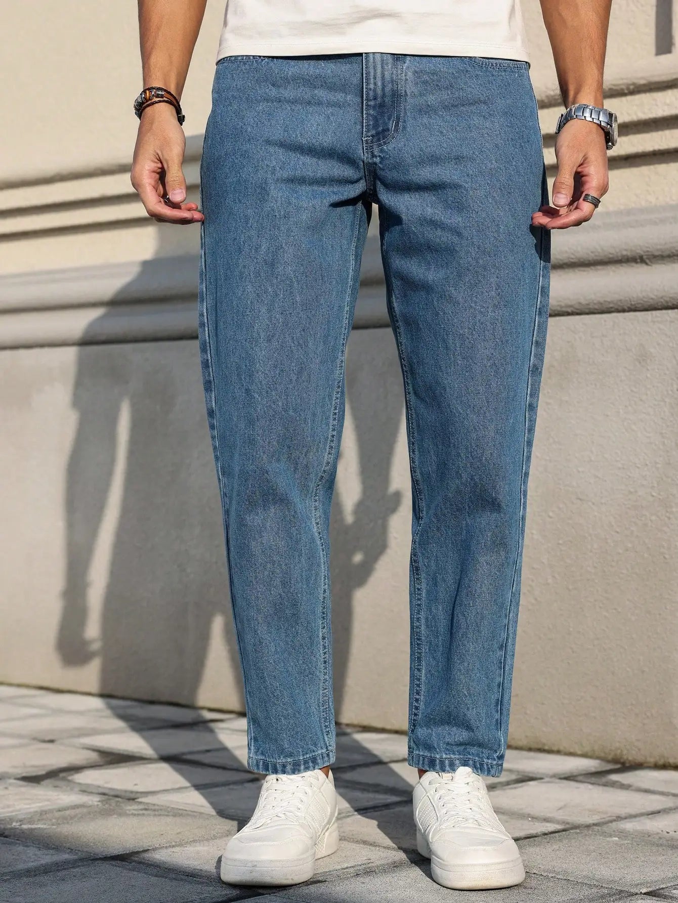Men's jeans are made of classic blue denim fabric with a loose fit