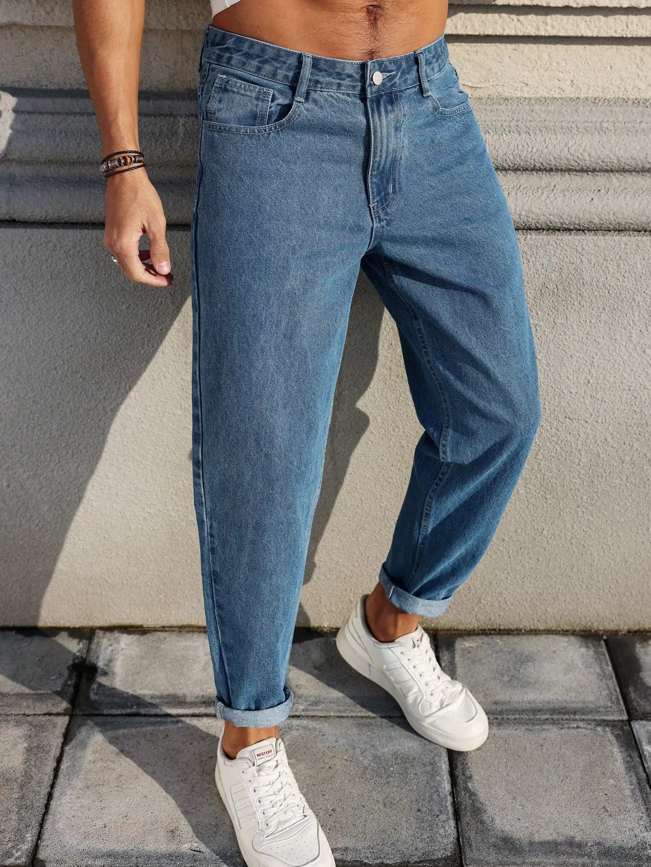 Men's jeans are made of classic blue denim fabric with a loose fit
