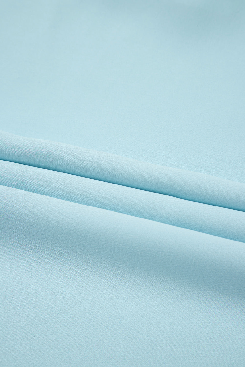 Light blue fabric with folds on a matching background
