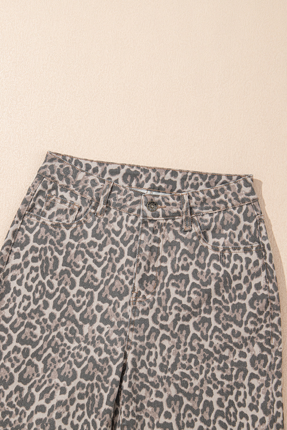 Leopard print pants on a beige background