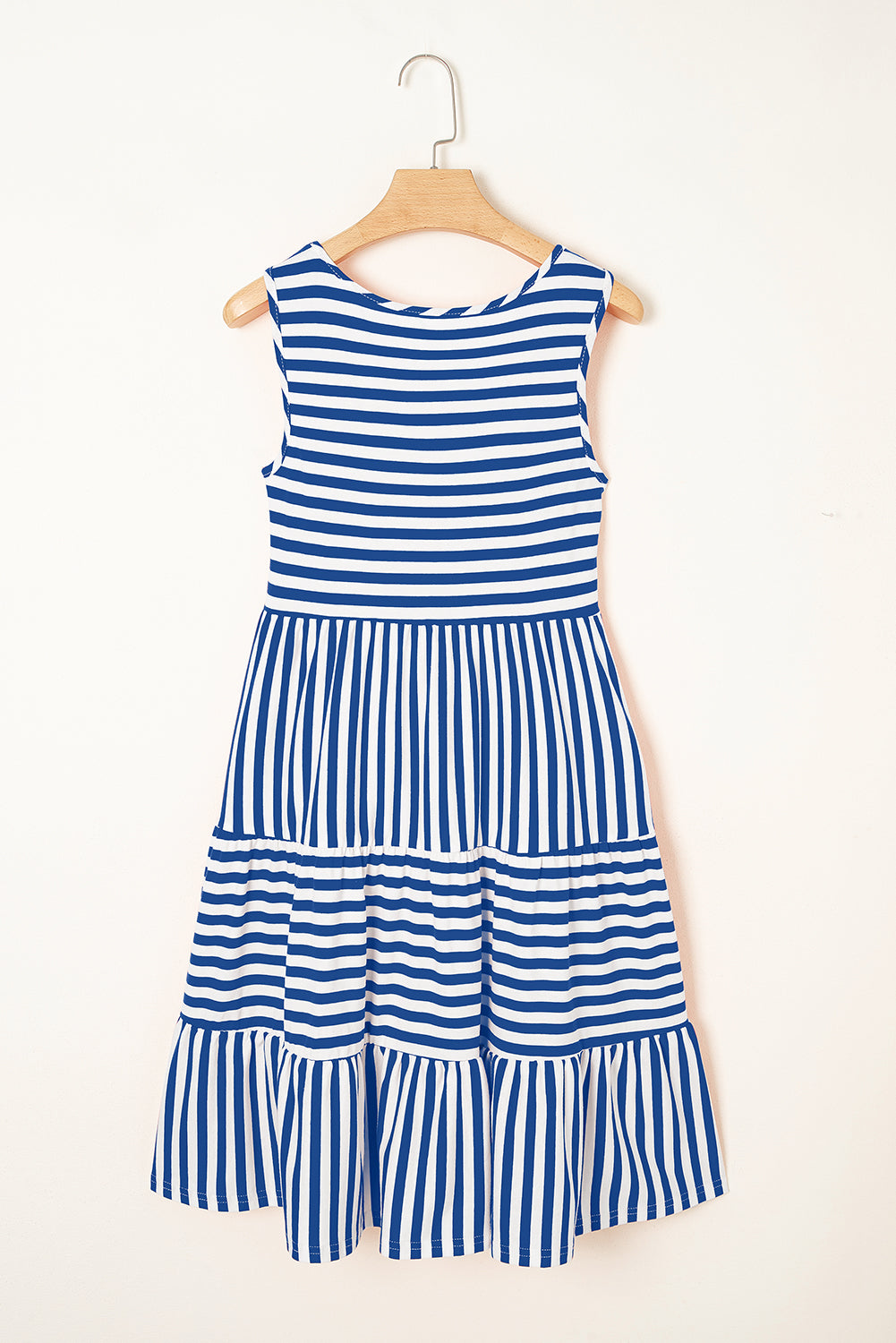 Blue and white striped dress on a hanger against a white background