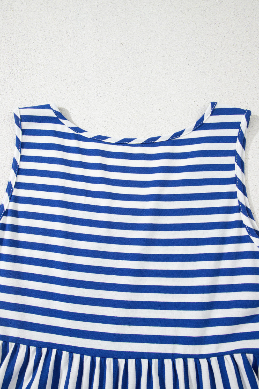 Blue and white striped dress on a white background