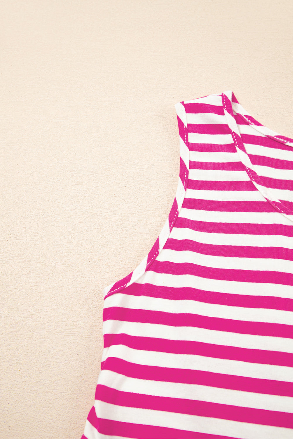 Close-up of a pink and white striped garment on a beige background