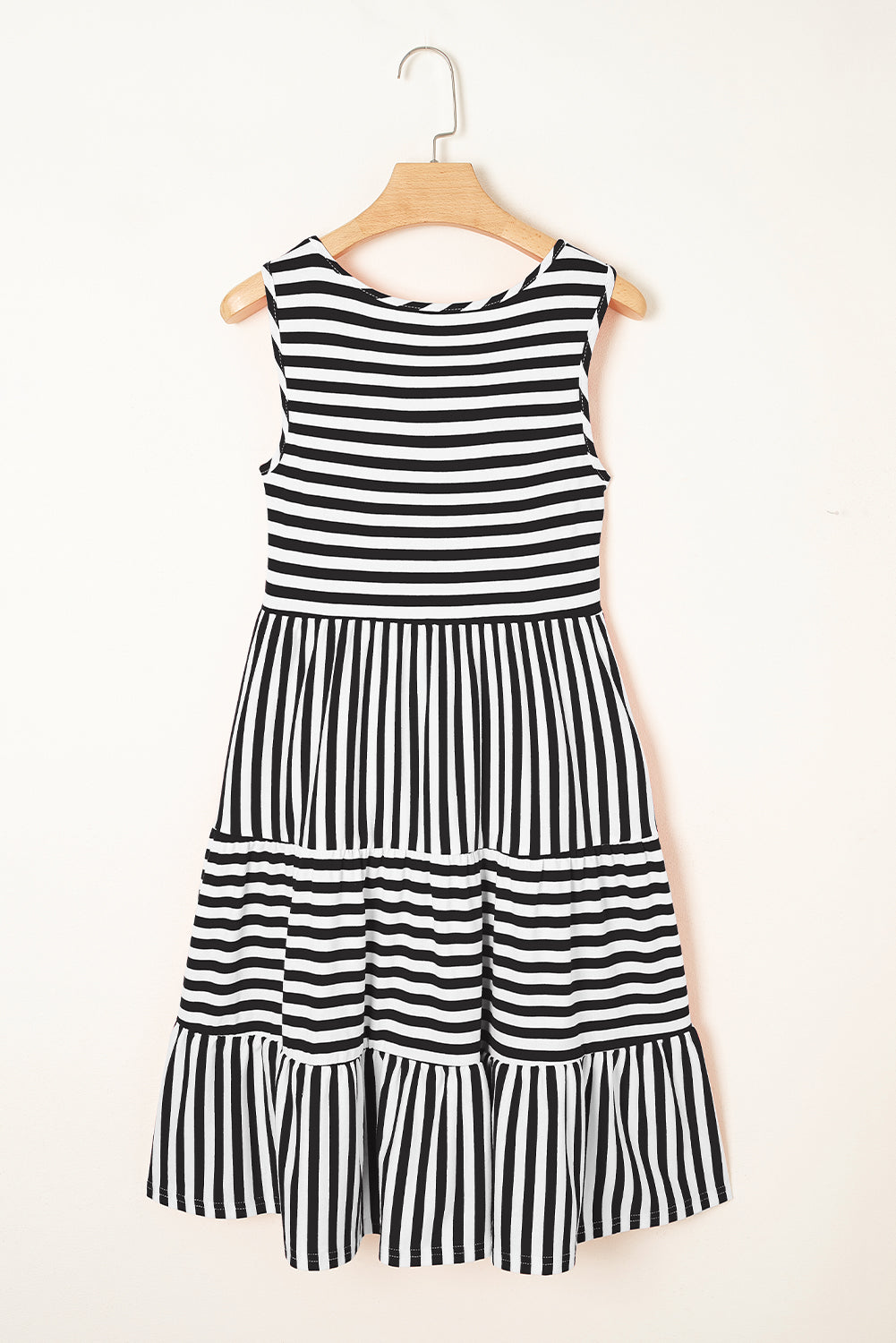 Black and white striped dress on a hanger against a white background