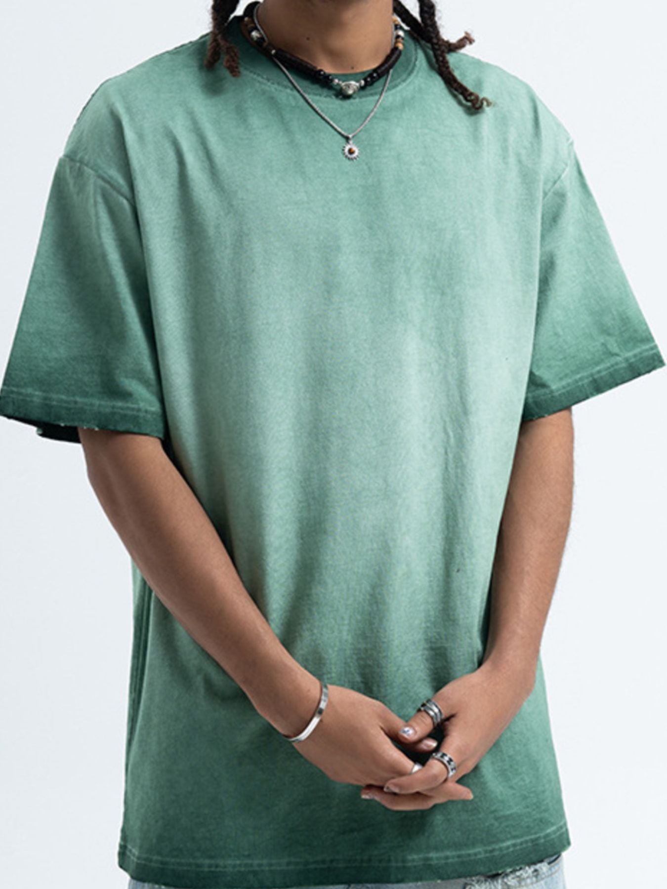 Person wearing a green t-shirt on a white background