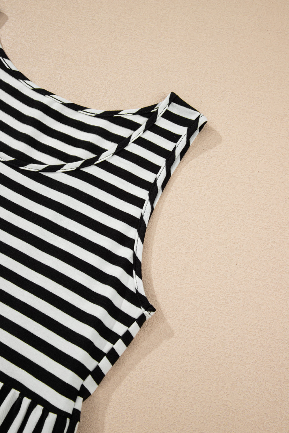 Black and white striped dress on a beige background